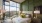 Furnished bedroom with glass wall and olive green accent wall